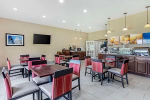 um restaurante com mesas e cadeiras e um bar em Comfort Inn & Suites em La Grange