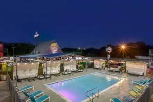 a pool at night with chairs and a tent at Heights House Hotel, Ascend Hotel Collection in Houston