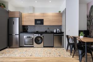 a kitchen with a washer and dryer and a table at Beach Apartments Valencia in Valencia