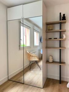 a glass door in a room with a chair at Le Belvédère in Orléans