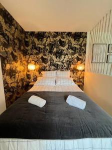 a bedroom with a large bed with two pillows at Le Belvédère in Orléans