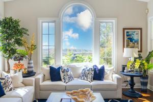 a living room with a couch and a large window at Escape to Luxury Newport Coast Pelican Gated Home in Newport Beach