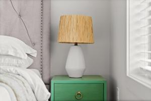 a lamp on a green night stand next to a bed at Crescent Moon Palace - A Luxury Home with Pool, Parking, Just steps to the Beach in Panama City Beach