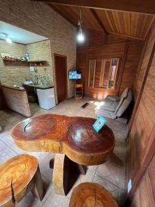 une grande table basse en bois dans un salon dans l'établissement Chalés Belo Vale - Rua do Curro, à Conceição da Ibitipoca