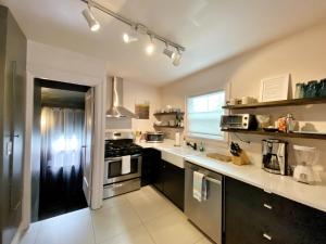 a kitchen with a black refrigerator and a stove at The Wesley Walla Walla in Walla Walla