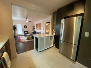 a kitchen with a stainless steel refrigerator and a living room at The Wesley Walla Walla in Walla Walla