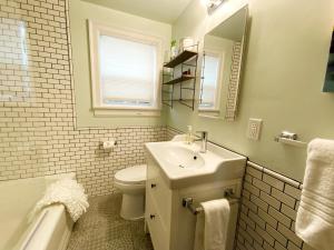 a bathroom with a sink and a toilet and a mirror at The Wesley Walla Walla in Walla Walla
