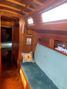 a seat in the back of a boat with a window at Pāvilostas_laivas in Pāvilosta