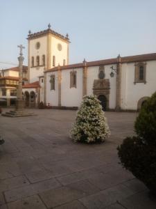 a large building with a clock tower and a plant at Bragança Holiday Home new apartment with 2 bedrooms private parking in Bragança