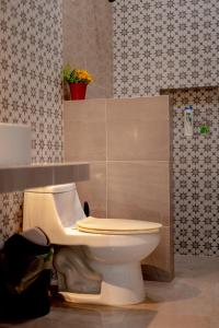 a bathroom with a toilet in a room at Casa Makech 2 in Valladolid +36 photos