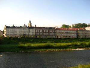 a large building next to a body of water at Hotel Albatros in Przemyśl