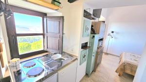 a small kitchen with a sink and a window at Casa Bakara balcón de Vejer in Vejer de la Frontera