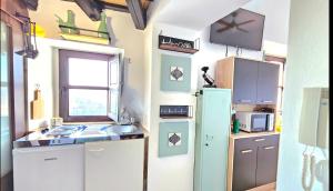 a small kitchen with a sink and a refrigerator at Casa Bakara balcón de Vejer in Vejer de la Frontera +12 photos
