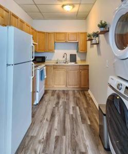 a kitchen with a white refrigerator and wooden cabinets at Modern and chic home with fine furnishing in Springfield