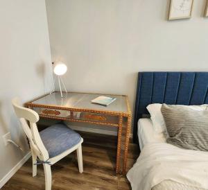 a desk with a lamp and a chair next to a bed at Modern and chic home with fine furnishing in Springfield