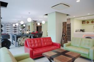 a living room with red chairs and a table at 823 Tourist Hotel in Jinhu