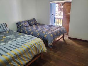 Ένα ή περισσότερα κρεβάτια σε δωμάτιο στο Hospedaje Victoria Chota