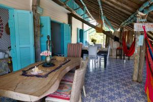 a dining room with a wooden table and blue doors at Golden Sea Casa Boutique in Archibolds +29 photos