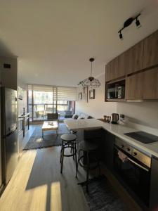 a kitchen with a table and chairs in a room at Departamento en pucon in Pucón