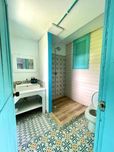 a bathroom with a sink and a toilet at Golden Sea Casa Boutique in Archibolds
