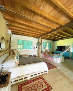 a bedroom with two beds and a wooden ceiling at Golden Sea Casa Boutique in Archibolds