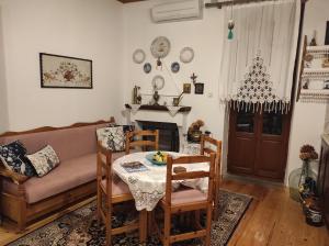 a living room with a table and a couch at Rita' s House Glossa Skopelos in Glossa
