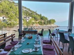 a dining room with a table and a view of the ocean at Rooms by the sea Cove Bristova - Hvar - 12140 in Bogomolje