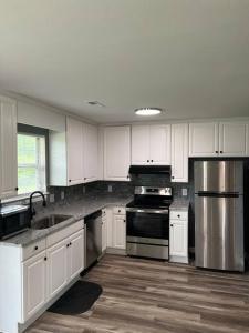 a kitchen with white cabinets and a stainless steel appliance at Beautiful Home In Greenville in Greenville