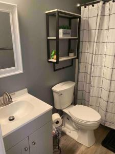 a bathroom with a toilet and a sink and a shower at Beautiful Home In Greenville in Greenville