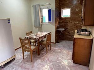 a kitchen with a table and chairs in a room at 12 S in El Alamein