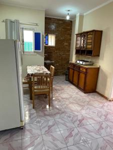 a kitchen with a table and chairs and a kitchen with a counter at 12 S in El Alamein