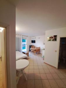 a room with a living room and a kitchen with a table at Apartments by the sea Podaca, Makarska - 21547 in Zaostrog