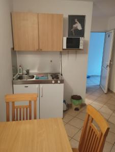 a small kitchen with a table and a microwave at Apartments by the sea Podaca, Makarska - 21547 in Zaostrog