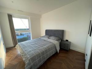 a bedroom with a bed and a large window at Kingston Star in Kingston upon Thames