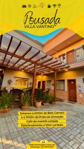 a building with a yellow sign in front of it at Pousada Villa Vantino in Penha