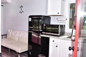 a kitchen with a black refrigerator and a microwave at Best little Fredericksburg Bed and Breakfast Unit2 in Fredericksburg