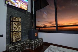 a fireplace with a television on top of it at Casa Zafiro in Monteverde Costa Rica
