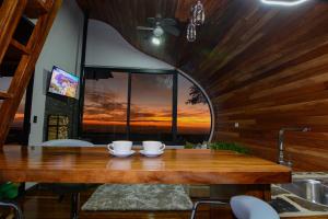 a dining room with a wooden table and a window at Casa Zafiro in Monteverde Costa Rica