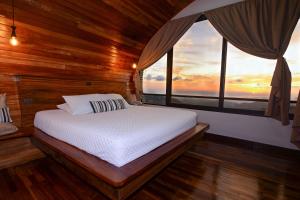 a bedroom with a bed with a view of the ocean at Casa Zafiro in Monteverde Costa Rica