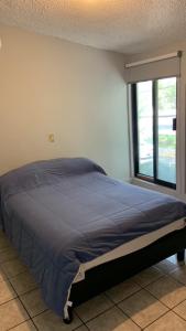 a bed in a bedroom with a large window at Mirador in Monterrey