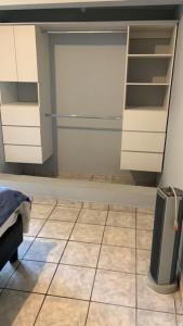 a kitchen with white cabinets and a tiled floor at Mirador in Monterrey