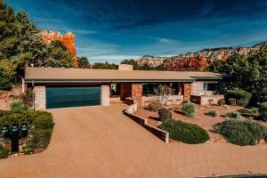 a brick house with a mountain in the background at Jacuzzi, Walk to Trails, Stunning Views, Mid-Century Modern,Pool in Sedona