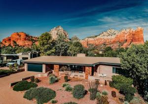 a building with a mountain in the background at Jacuzzi, Walk to Trails, Stunning Views, Mid-Century Modern,Pool in Sedona