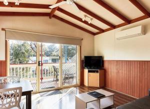 a living room with a couch and a tv at Marengo Family Caravan Park in Marengo