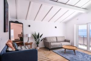 a living room with a couch and a table at Villa Del Mar Omiš in Omiš