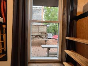 a door to a patio with a view of a deck at Le Bed & Cocktail - Appartement sur l'Avenue du Mont-Royal in Montréal +7 photos