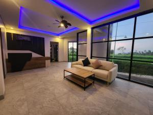 a living room with a couch and a table at Taman Dari Villa in Sudaji