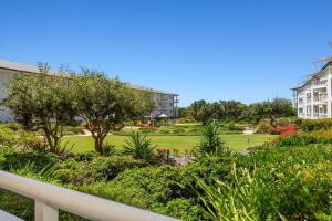 a view of the garden from the balcony of a building at Resort On The Beach 5118 with resort Pool in Kingscliff