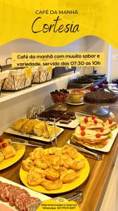 a buffet with many different types of food on display at Pousada Villa Vantino in Penha