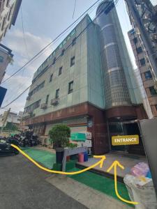 a building with a yellow ribbon in front of it at Coco Stay in Seoul
